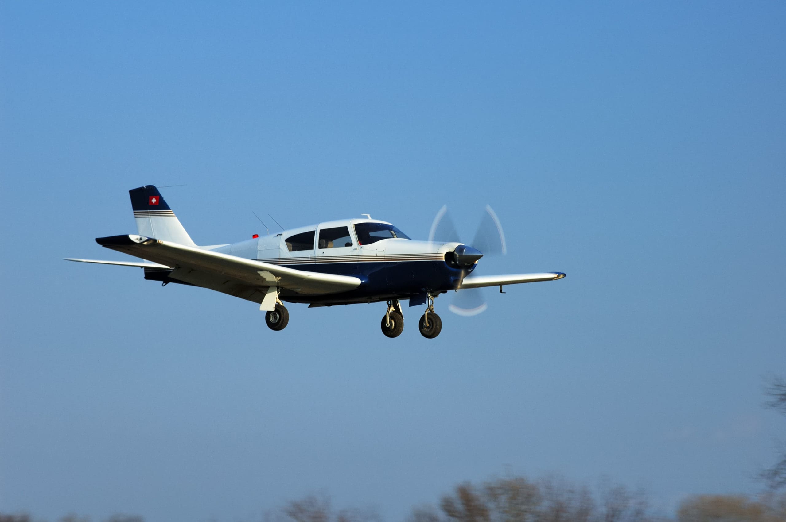 A light aircraft coming in to land at an airfield.